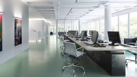 Foto: ein leeres Großraumbüro mit rund einem Dutzend PC-Arbeitsplätzen und großer Fensterfront