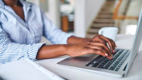 Foto: Nahaufnahme einer nicht zu erkennenden Frau am Laptop zu Hause